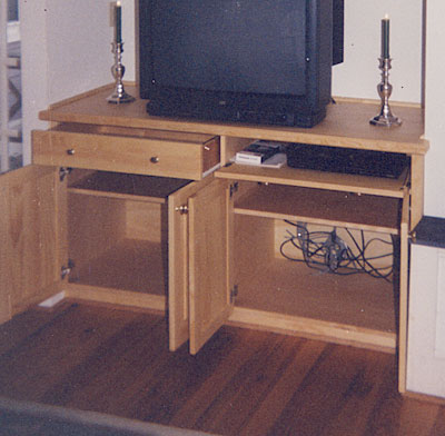 pine media center interior with glass display shelves